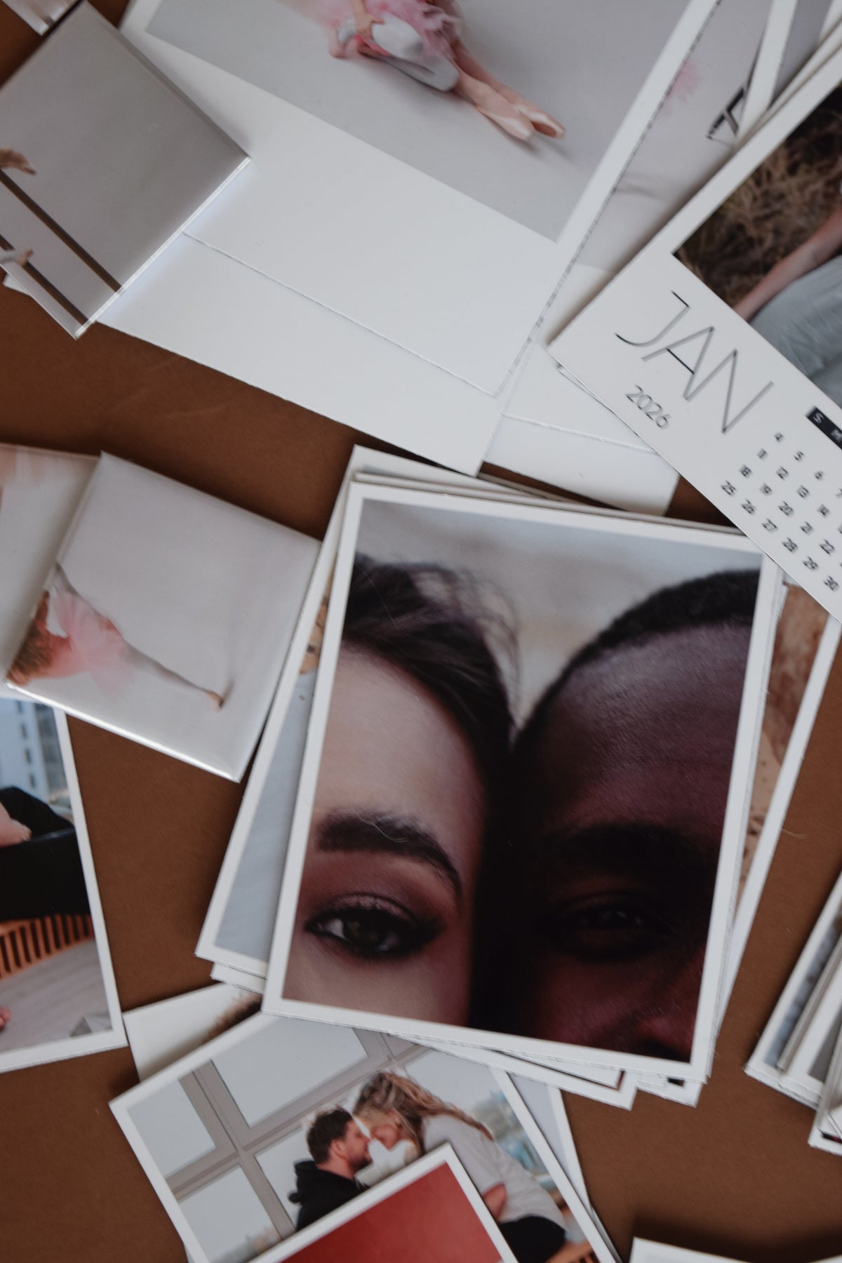 Collection of photographs on a brown surface